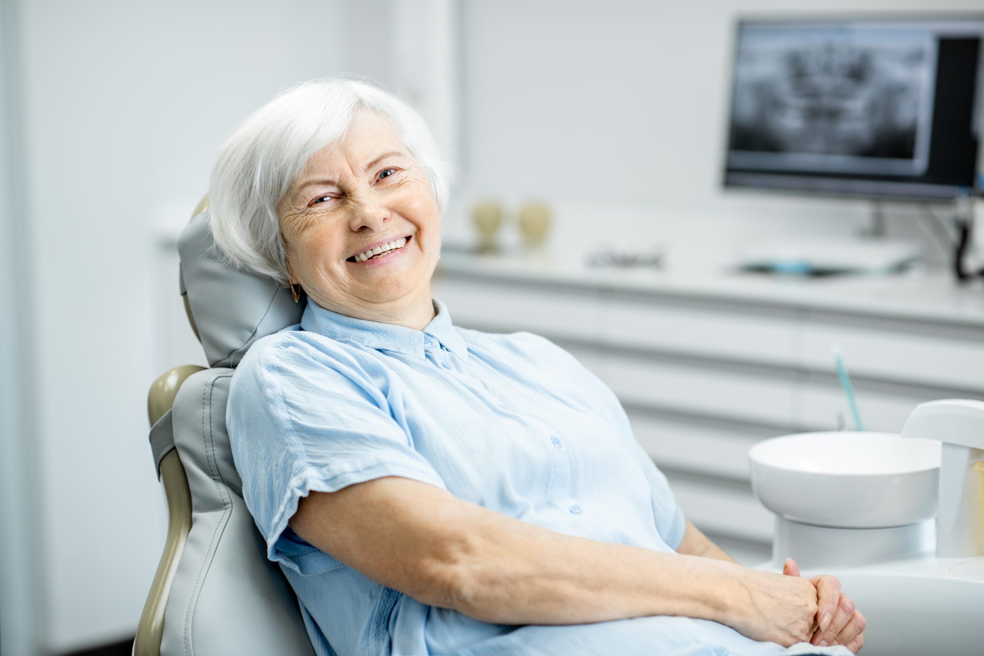 Happy patient relaxing in the treatment chair